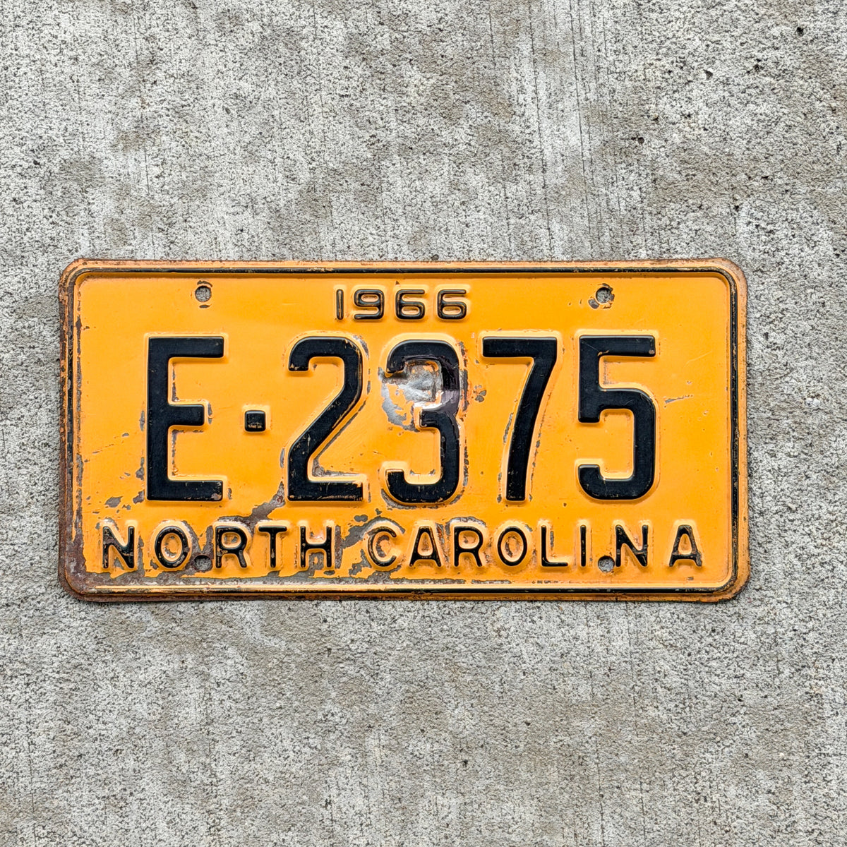 Photo of a 1966 North Carolina License Plate Auto Tag Garage Decor Vintage E 2375 with original patina