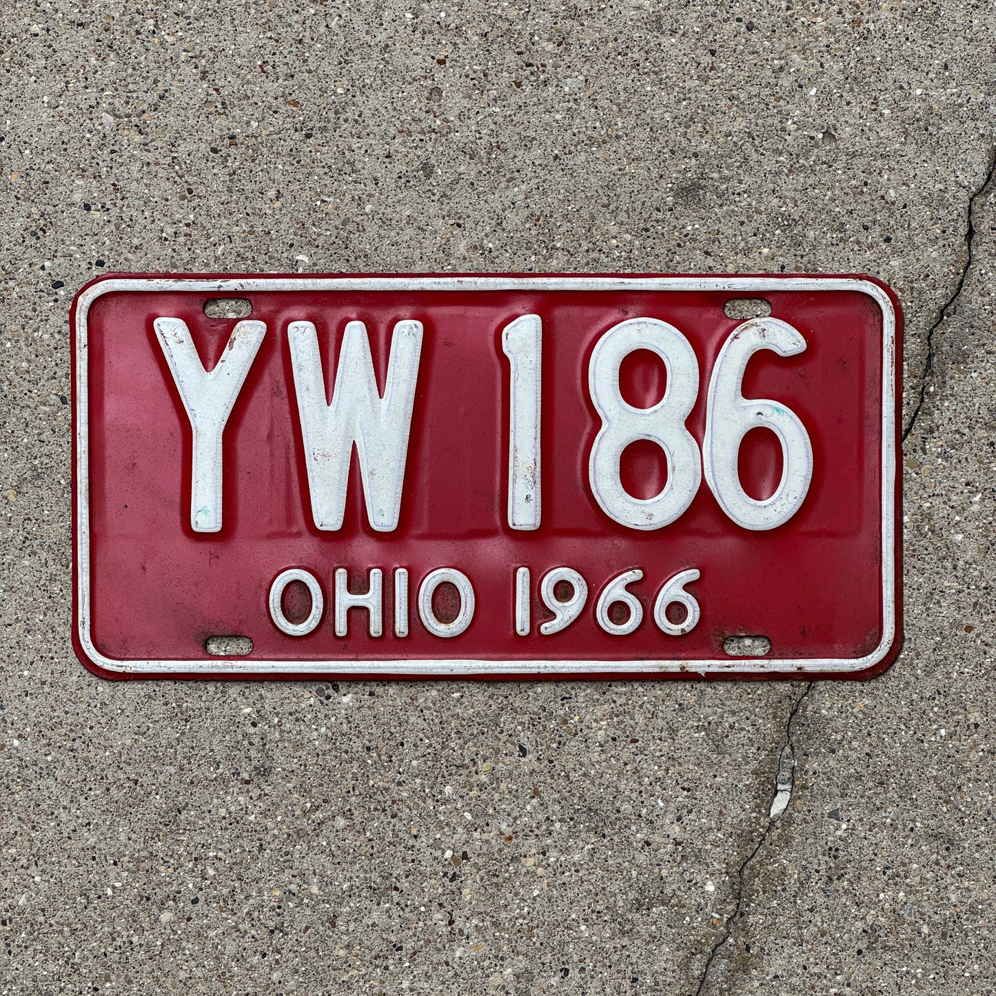 Photo of a 1966 Ohio License Plate Auto Tag 2 Vintage Garage YW 186 with original patina