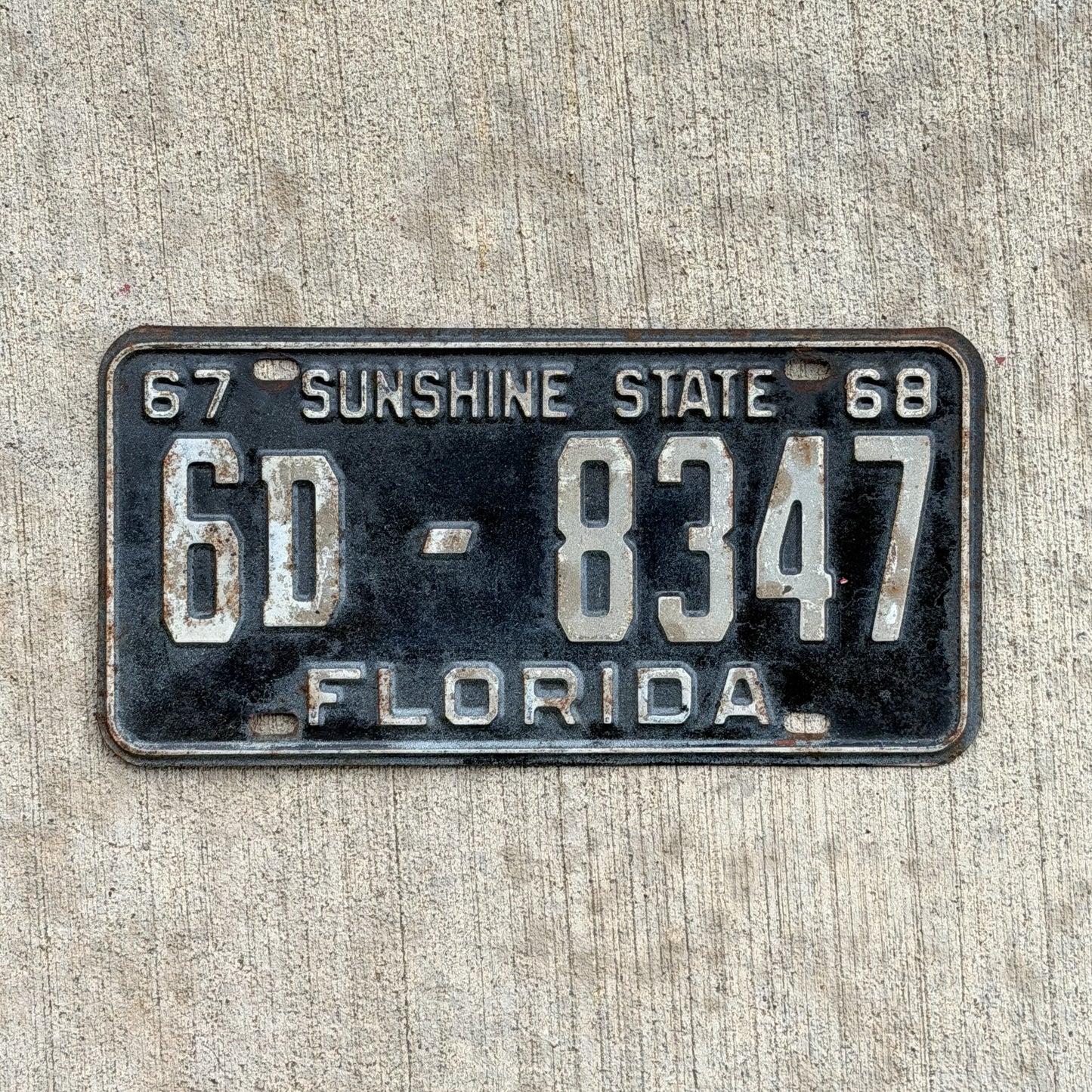 Photo of a 1967 1968 Florida License Plate Auto Tag Garage Decor Vintage YOM DMV Clear Number 6D 8347 with original patina