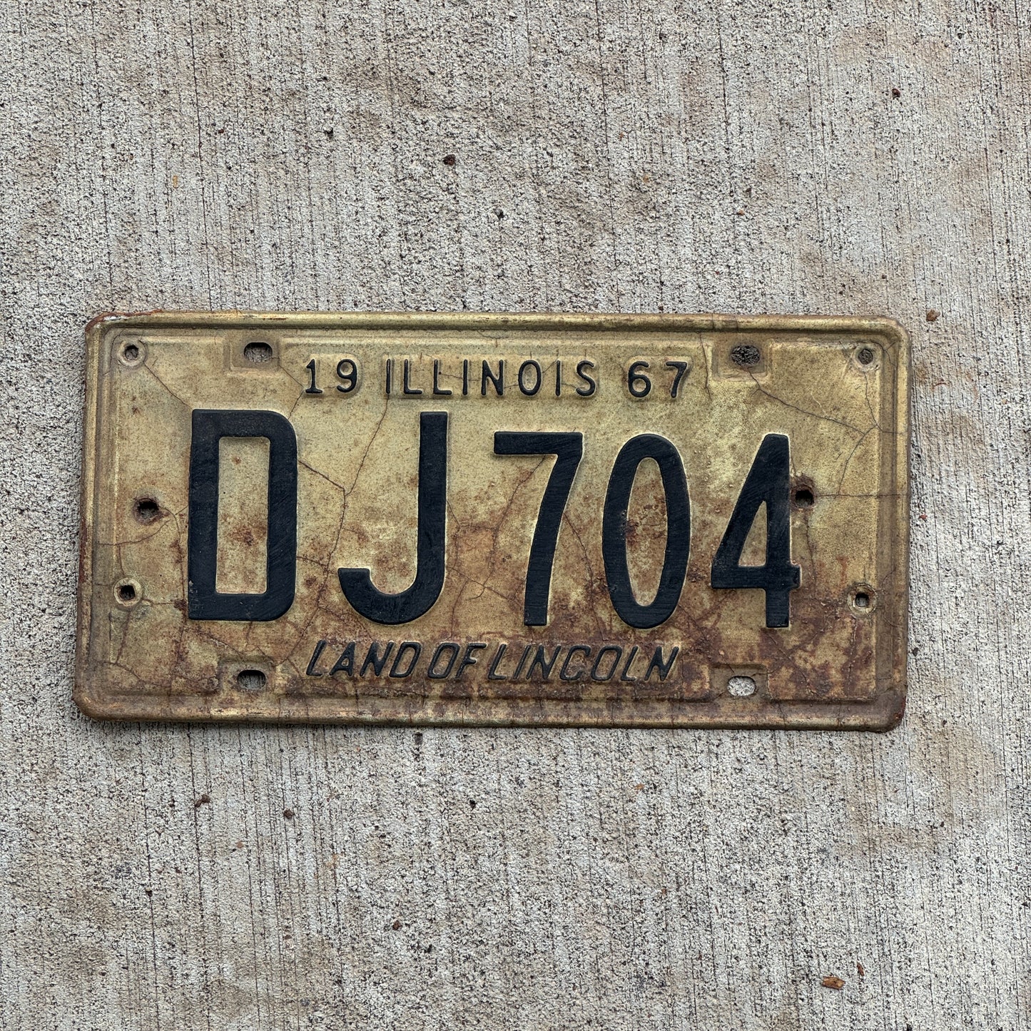 Photo of a 1967 Illinois License Plate Auto Tag 1 Vintage Garage DJ 704 with original patina