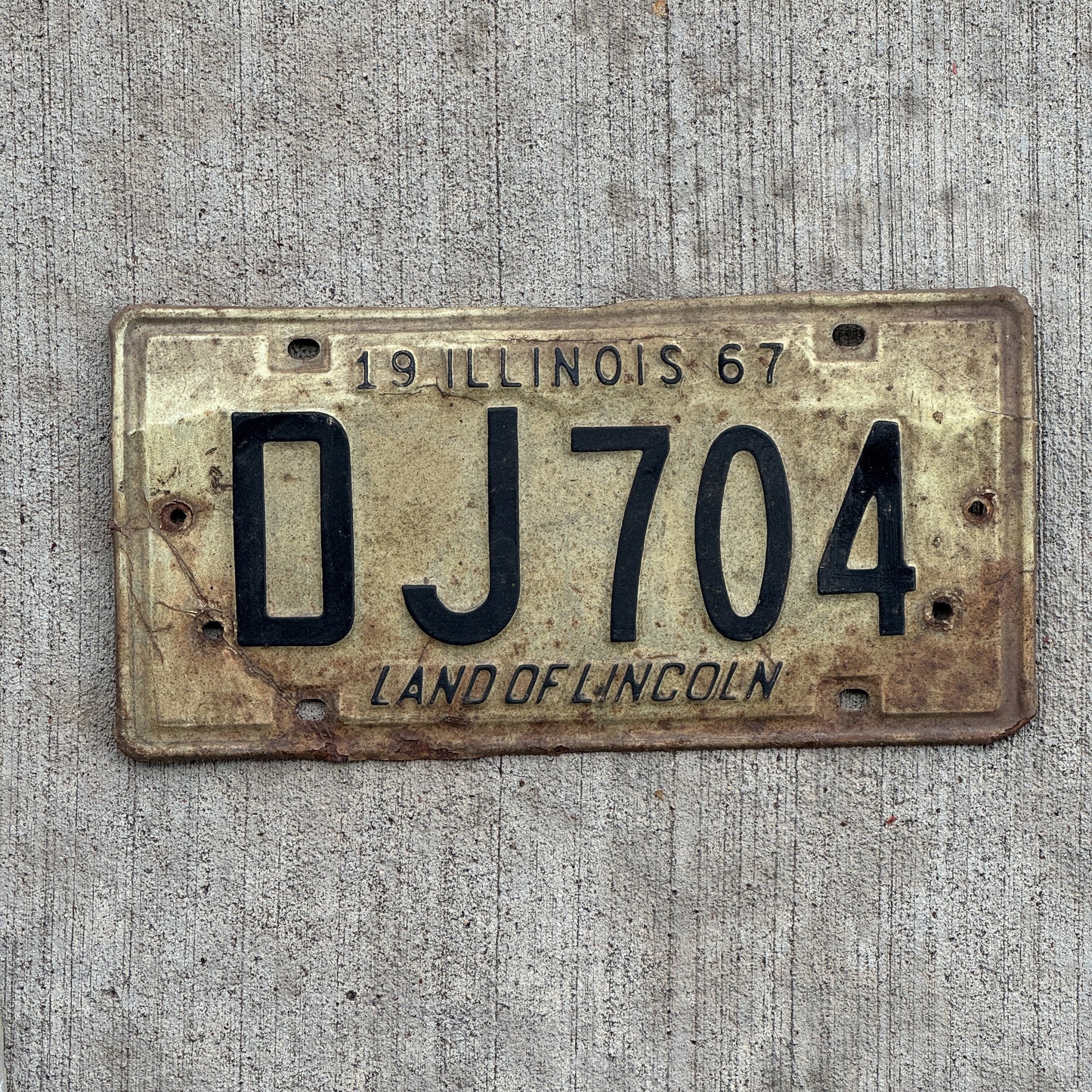 Photo of a 1967 Illinois License Plate Auto Tag 2 Vintage Garage DJ 704 with original patina