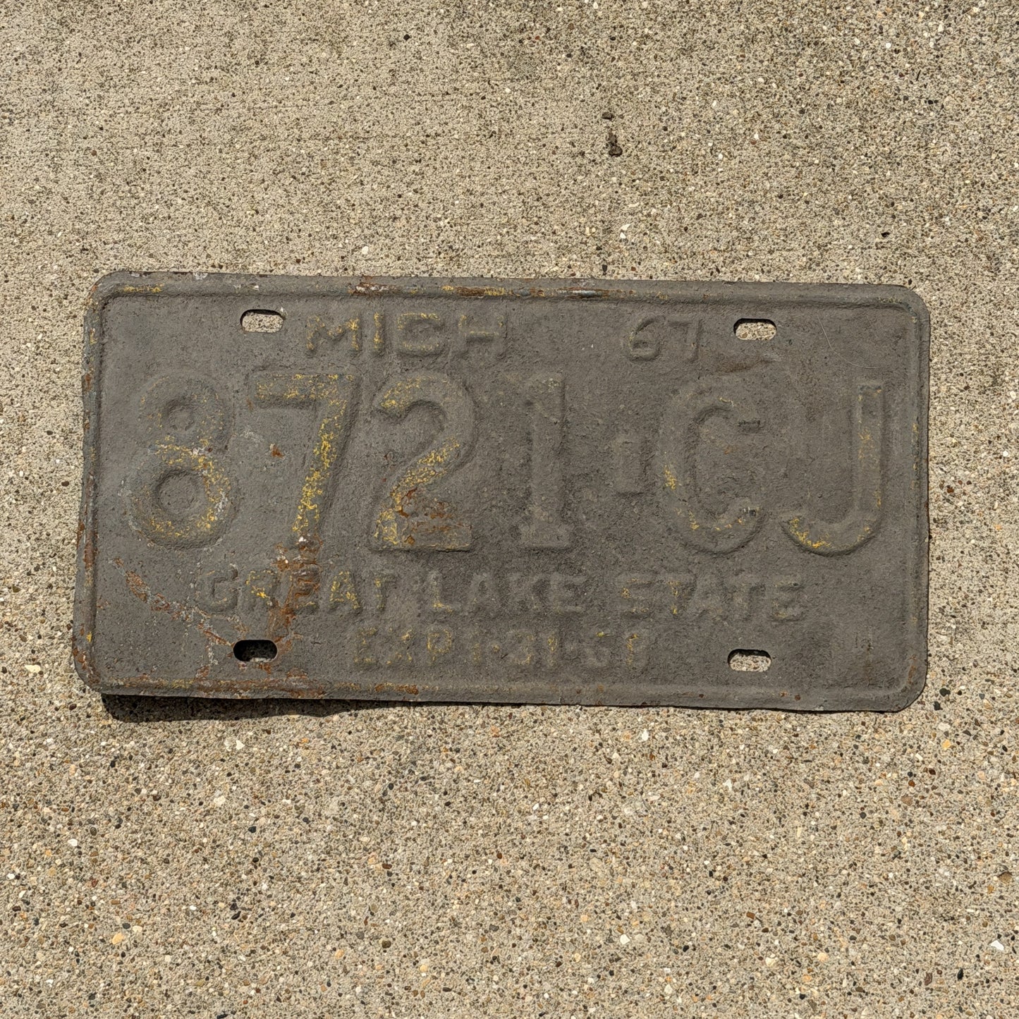Photo of a 1967 Michigan Commercial License Plate Auto Tag Garage Decor Vintage 8721 CJ with original patina