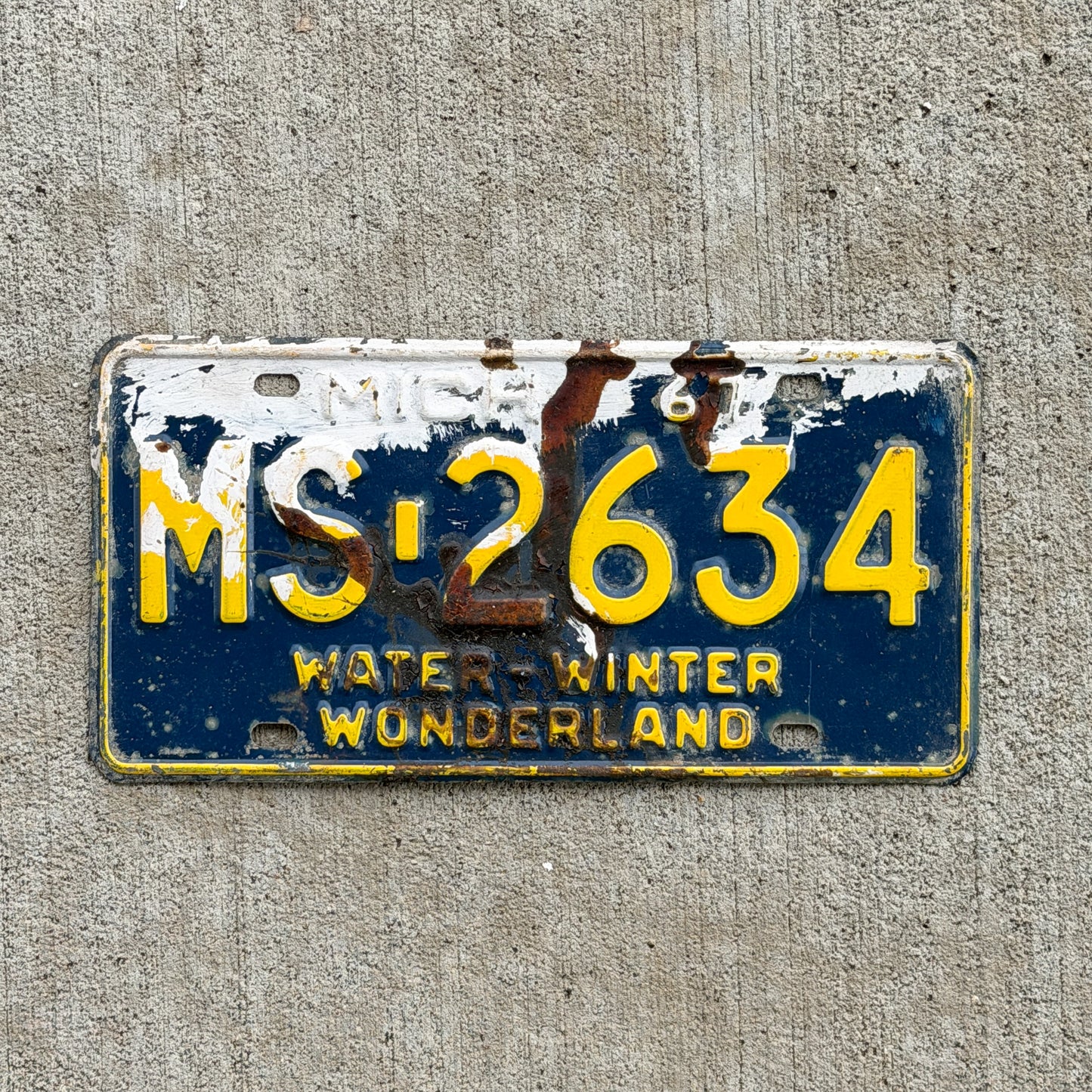 Photo of a 1967 Michigan License Plate Auto Tag Garage Decor Vintage MS 2634 with original patina
