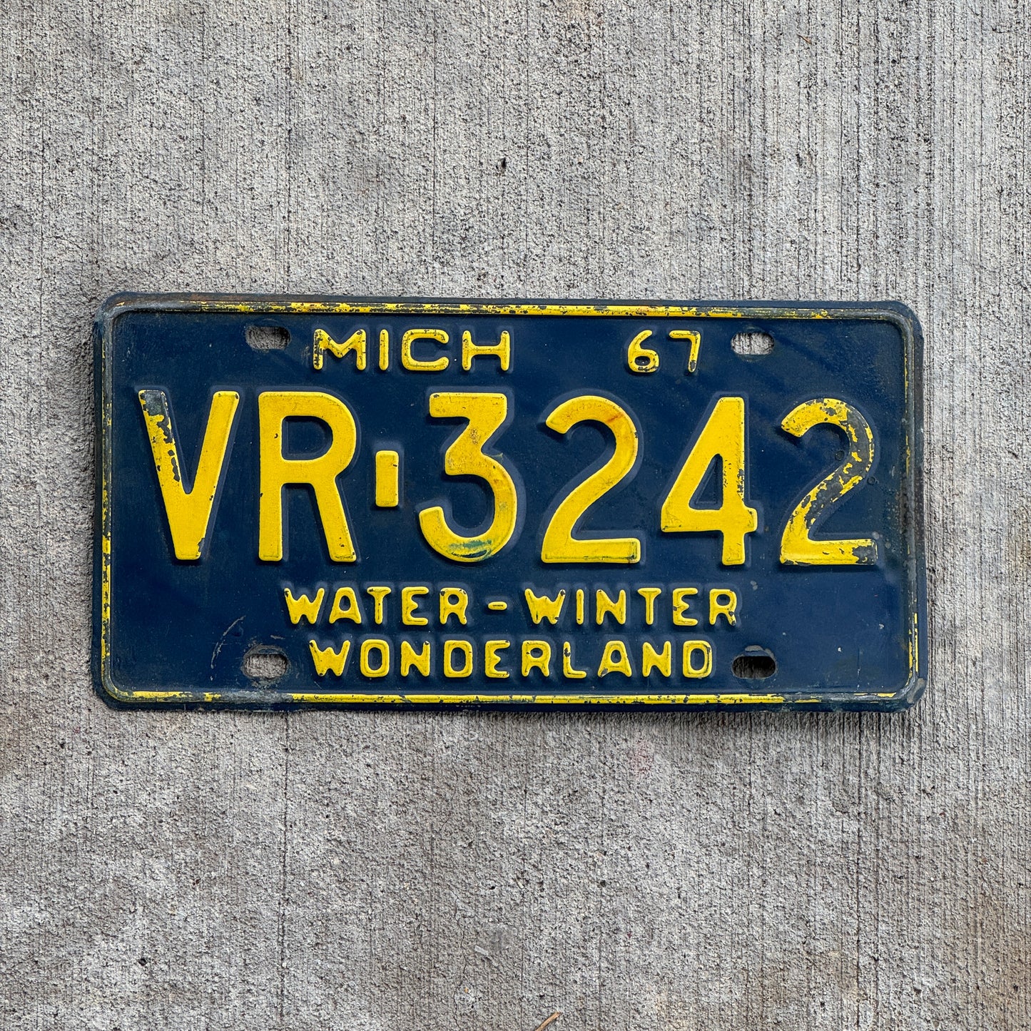 Photo of a 1967 Michigan License Plate Auto Tag Garage Decor Vintage VR 3242 with original patina