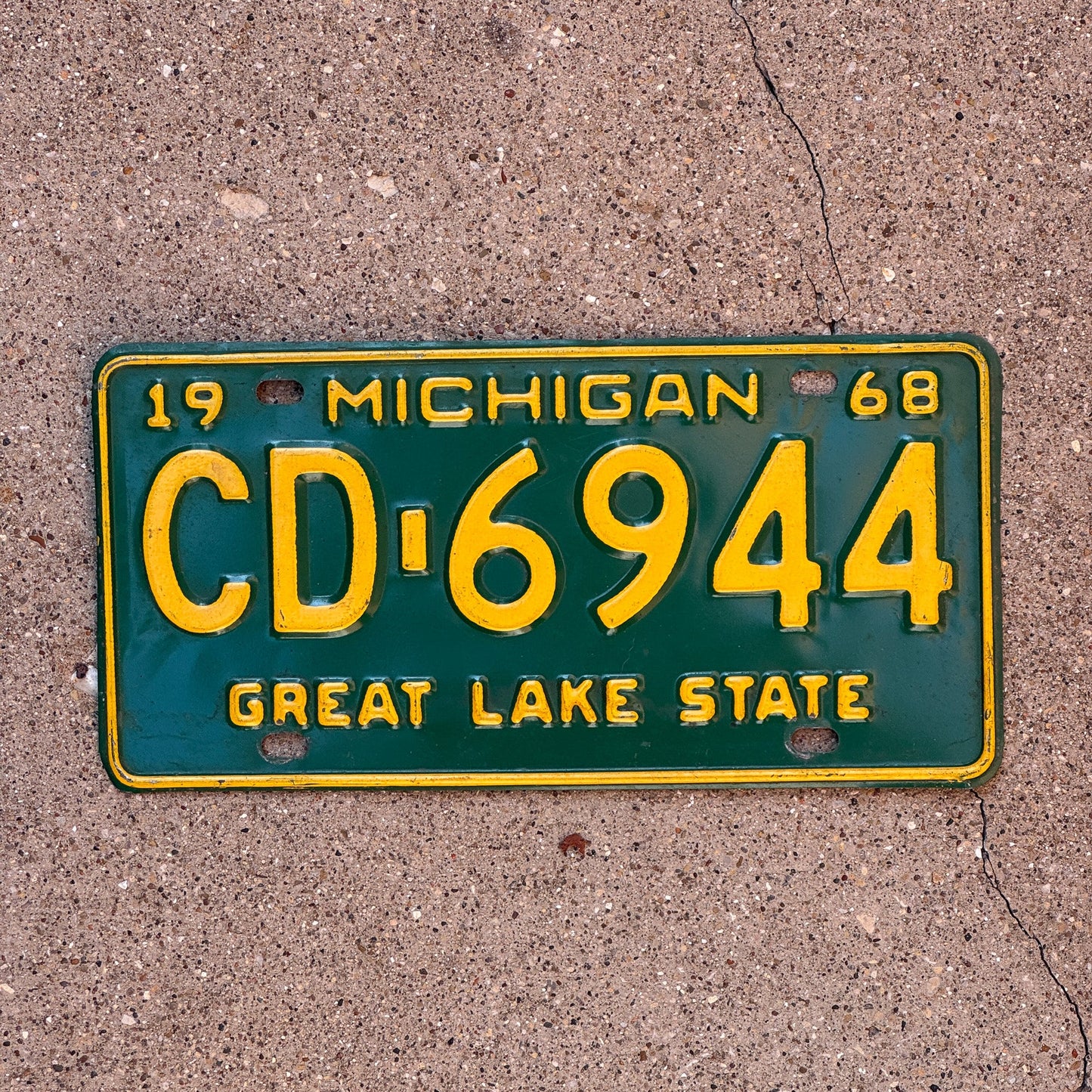 Photo of a 1968 Michigan License Plate Auto Tag Garage Decor Vintage CD 6944