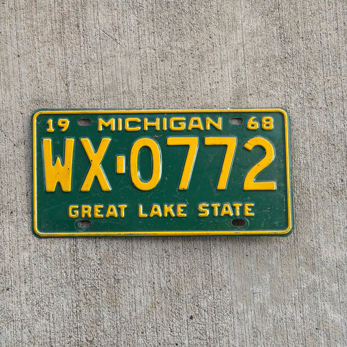 Photo of a 1968 Michigan License Plate Auto Tag Garage Decor Vintage WX 0772 with original patina