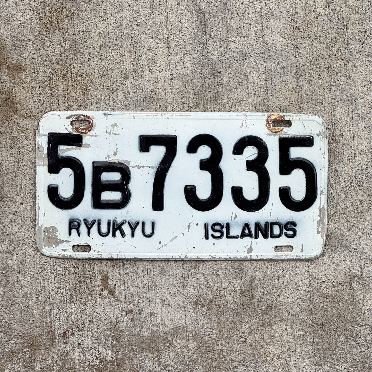 Photo of a 1968 Ryukyu Islands Japan License Plate Auto Tag Garage Decor Vintage Hard to Find 5B 7335 with original patina