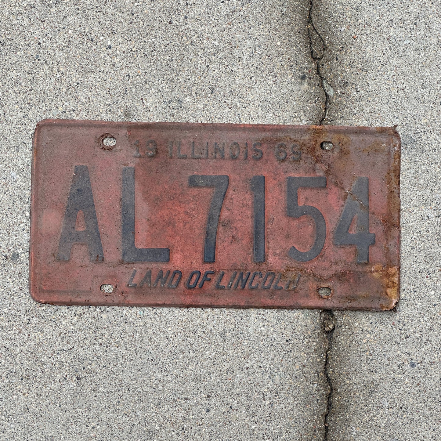 Photo of a 1969 Illinois License Plate Auto Tag Garage Decor Vintage AL 7154 with original patina