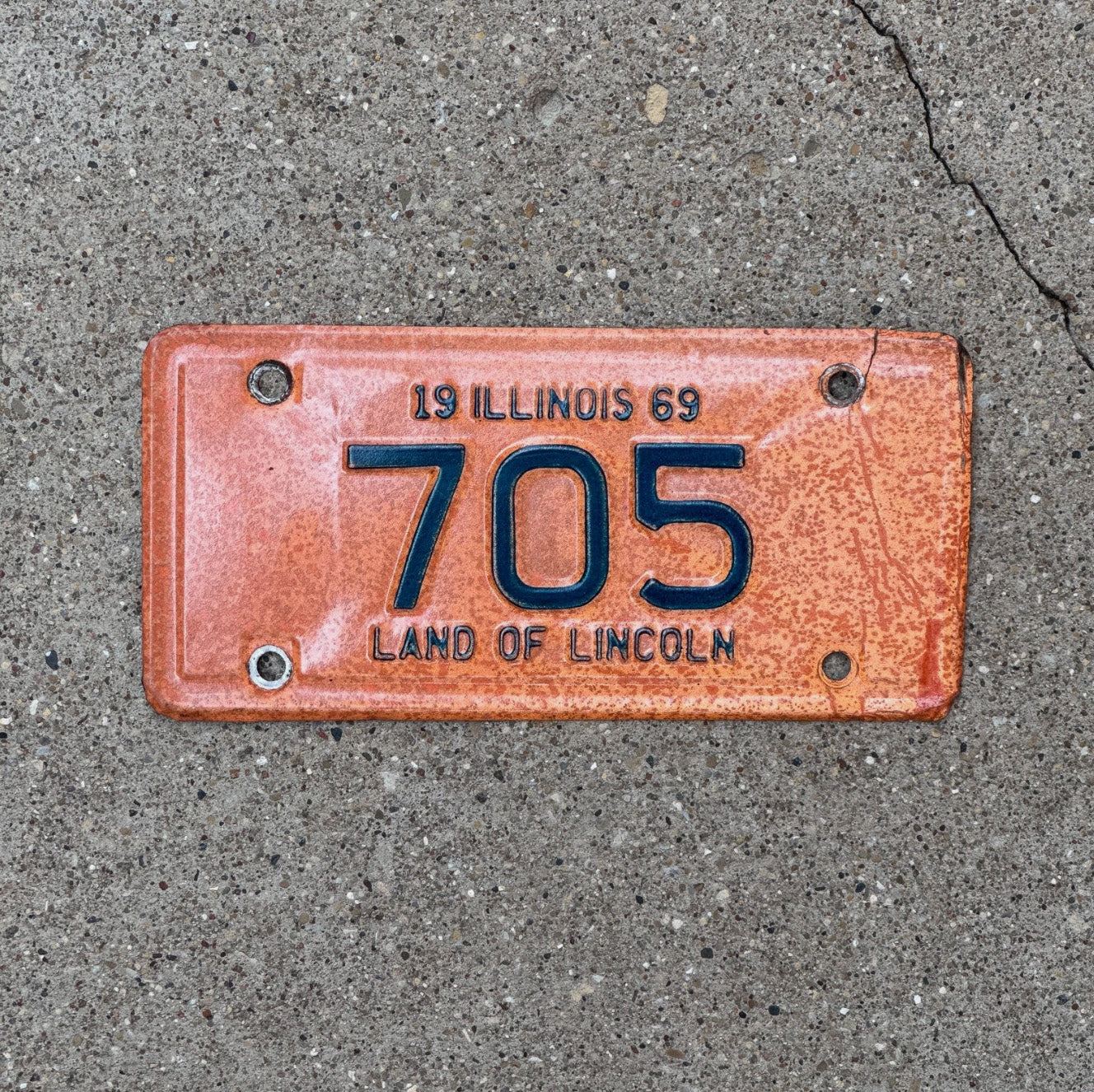 Photo of a 1969 Illinois Motorcycle License Plate Auto Tag Garage Decor Vintage Low Number Three Digit 705 with original patina