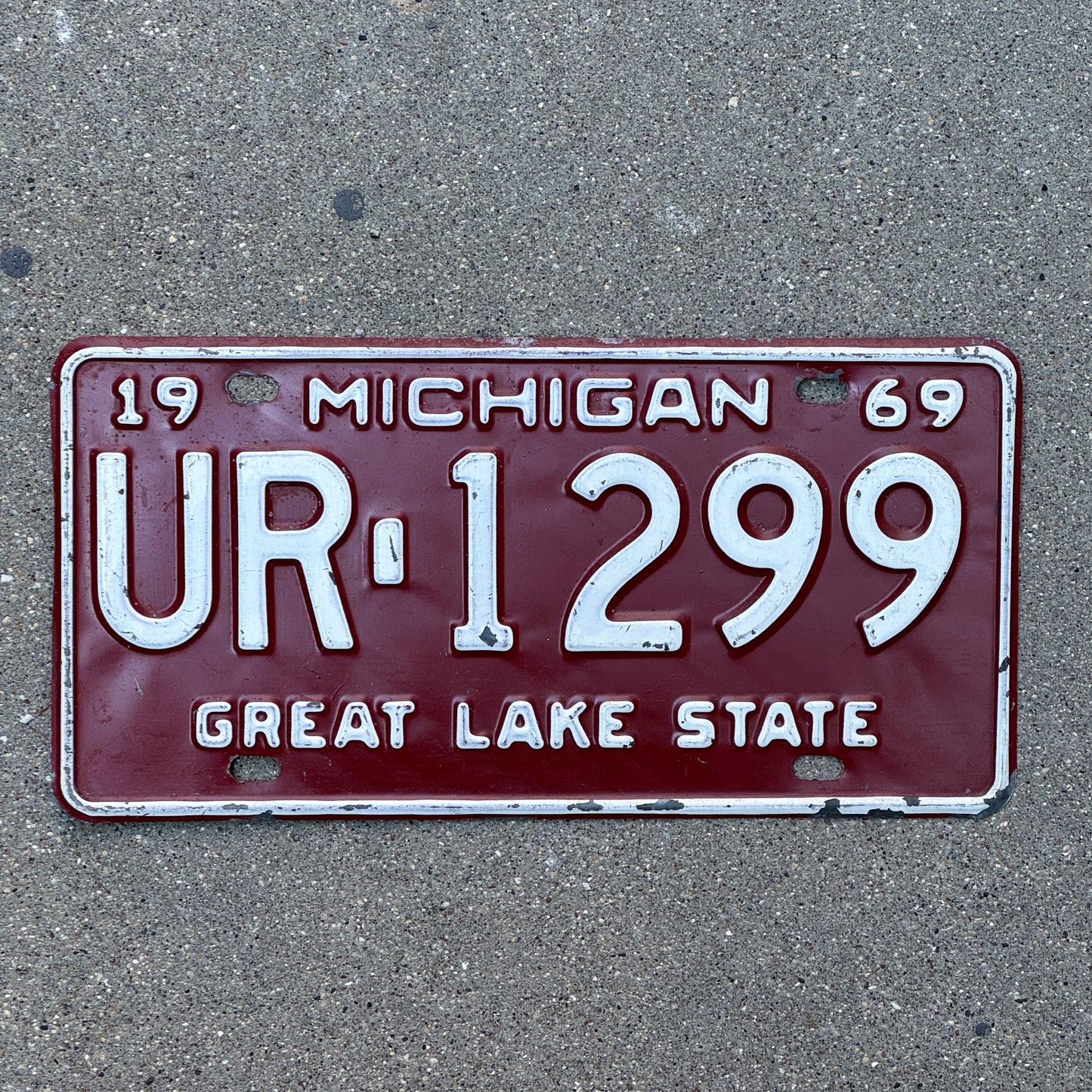 Photo of a 1969 Michigan License Plate Auto Tag Garage Decor Vintage UR 1299 with original patina