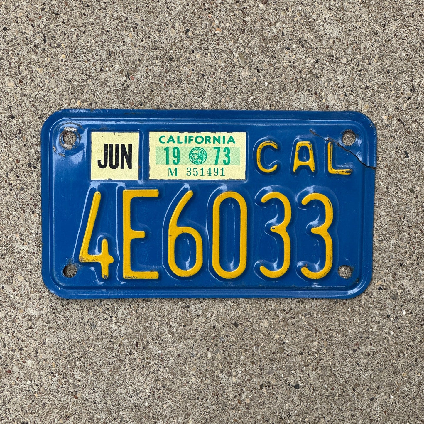 Photo of a 1970 1973 California Motorcycle License Plate Auto Tag Garage Decor Vintage 4E6033 with original patina