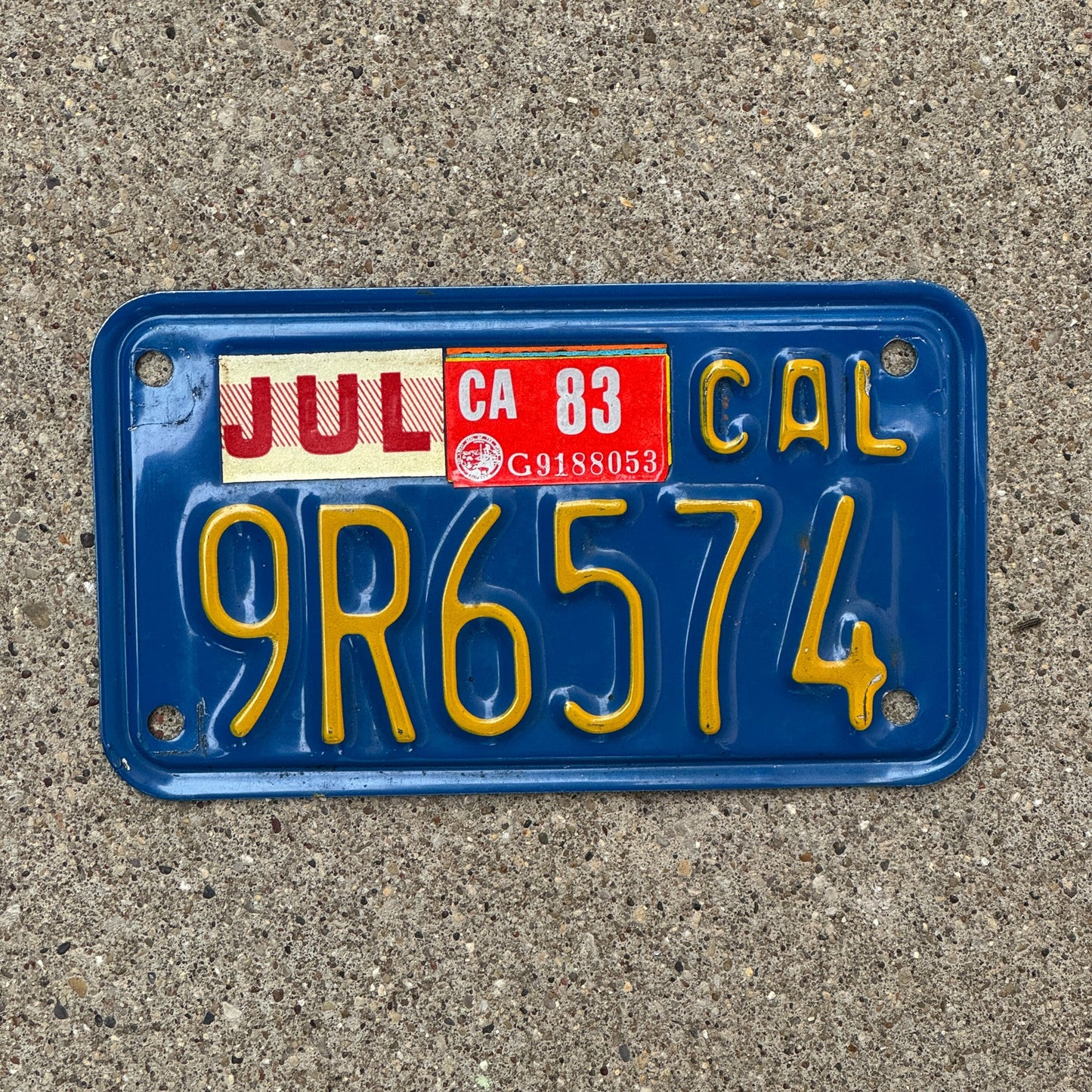 Photo of a 1970 1983 California Motorcycle License Plate Auto Tag Garage Decor Vintage 9R6574 with original patina