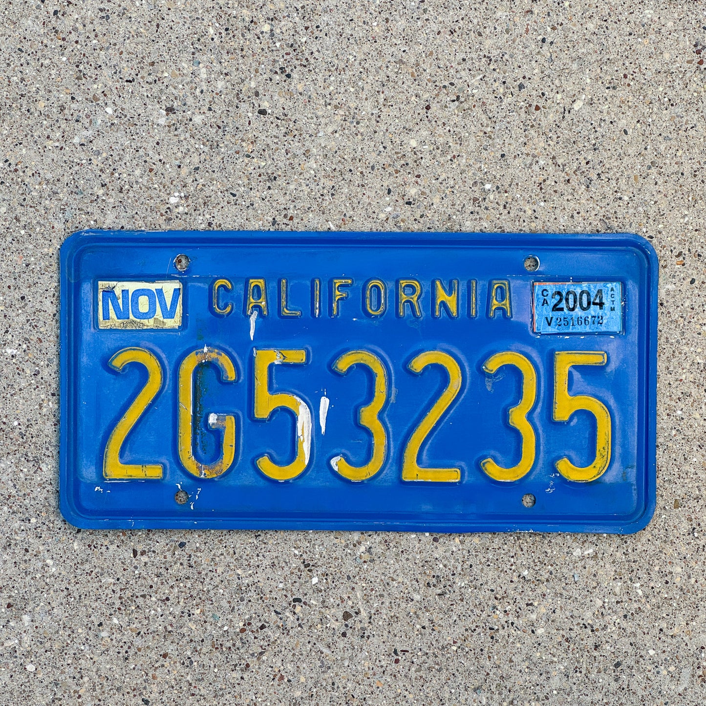 Photo of a 1970 2004 California Commercial License Plate Auto Tag Garage Decor Vintage 2G53235 with original patina