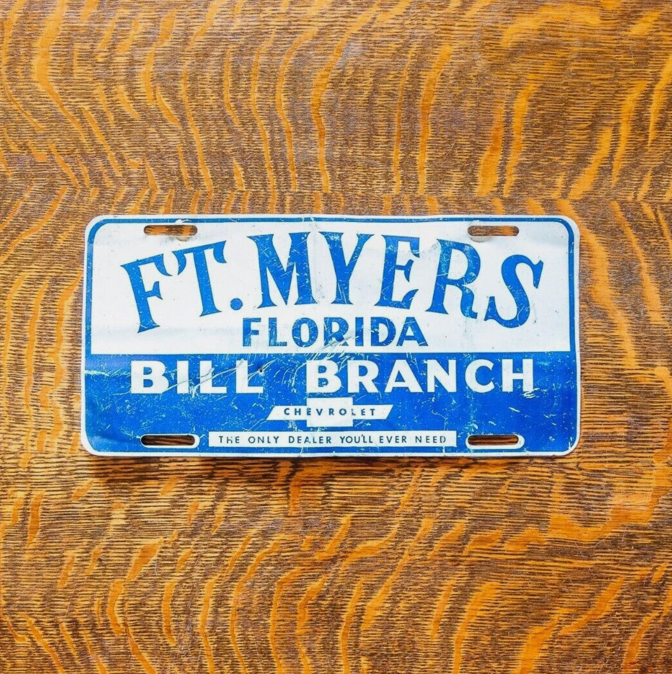 Photo of a 1970 Era Florida License Plate Booster License Plate Auto Tag Garage Decor Vintage Ft Myers Bill Branch Chevy with original patina