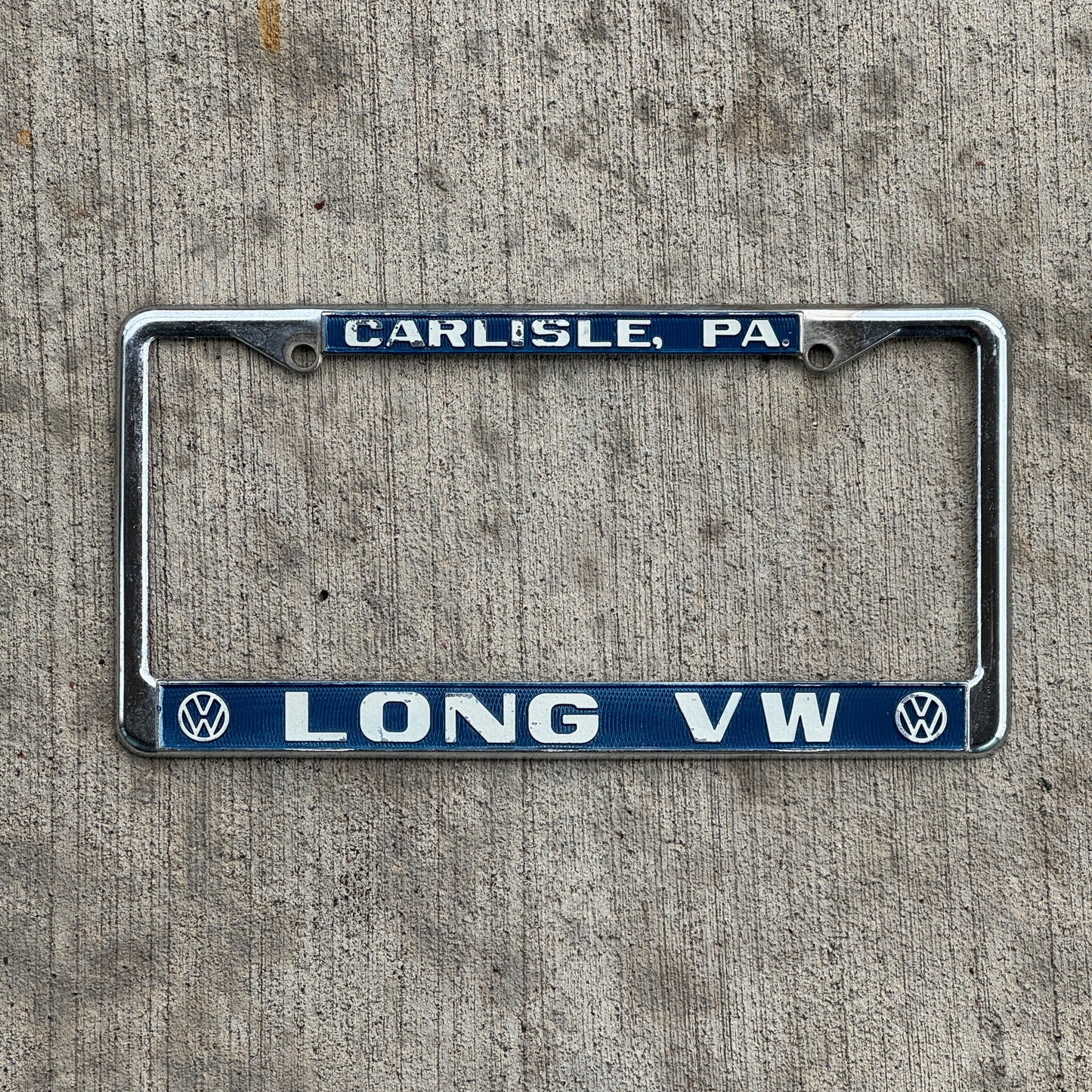 Photo of a 1970 Era Lloyd Long Volkswagen Carlisle Pennsylvania License Plate Frame Auto Tag Garage Decor Vintage VW Dealer with original patina