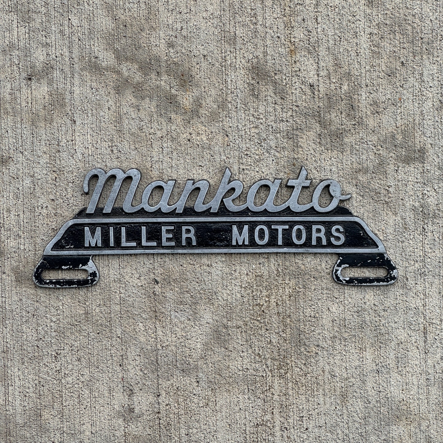 Photo of a 1970 Era Miller Motors Mankato Minnesota License Plate Topper Auto Tag Garage Decor Vintage Cast Aluminum with original patina