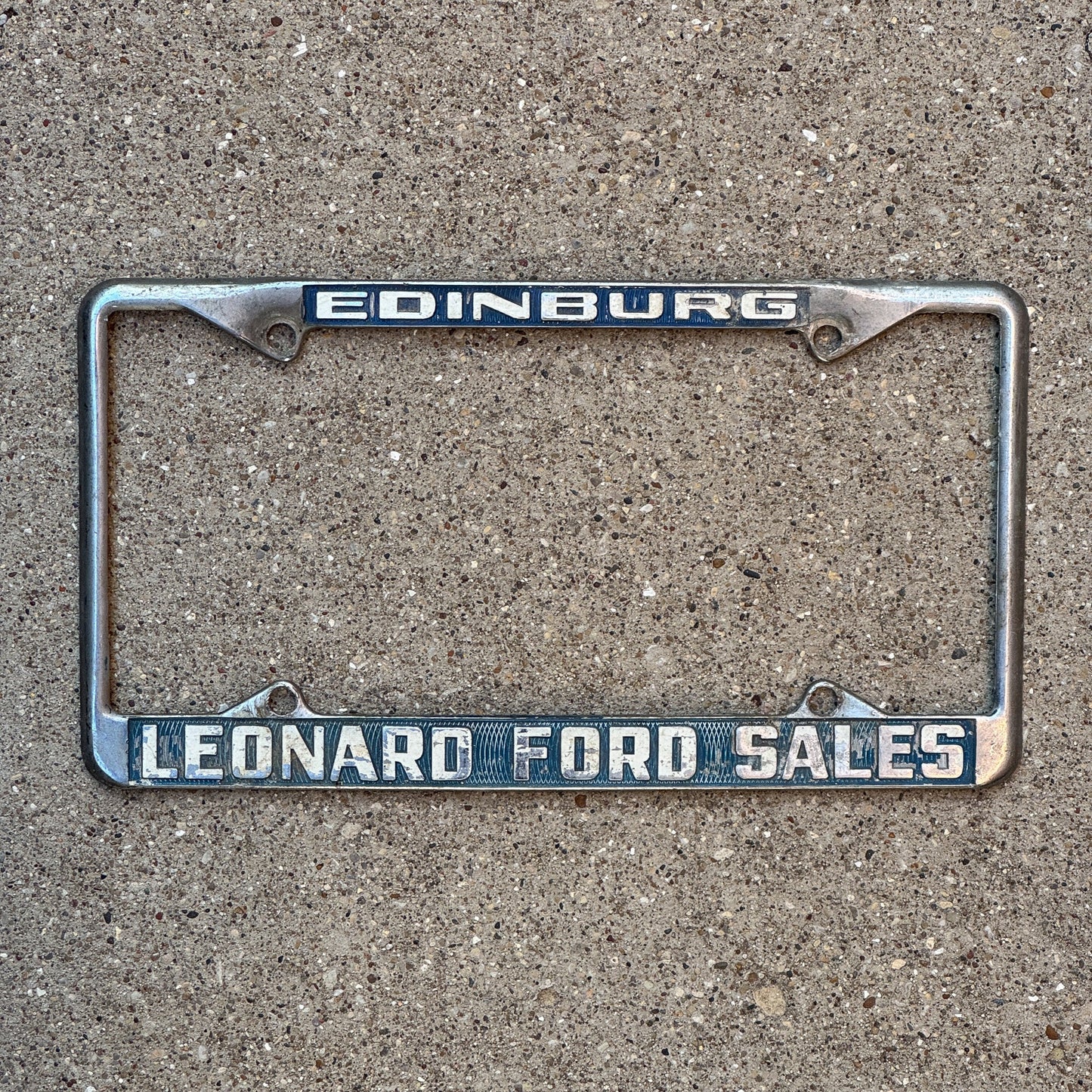 Photo of a 1970 Era Texas License Plate Frame Auto Tag Garage Decor Vintage Leonard Ford Sales Dealer Edinburg Leonard Ford Sales with original patina