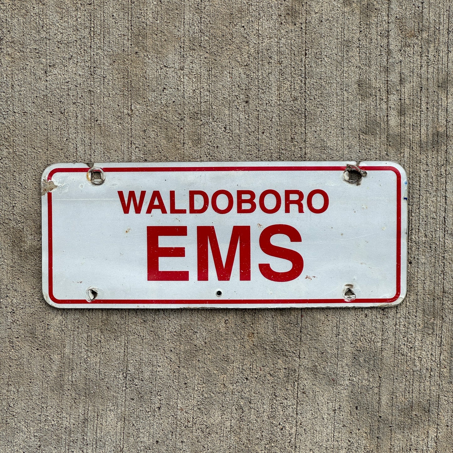 Photo of a 1970 Era Waldoboro Maine EMS License Plate Topper Auto Tag Garage Decor Vintage with original patina
