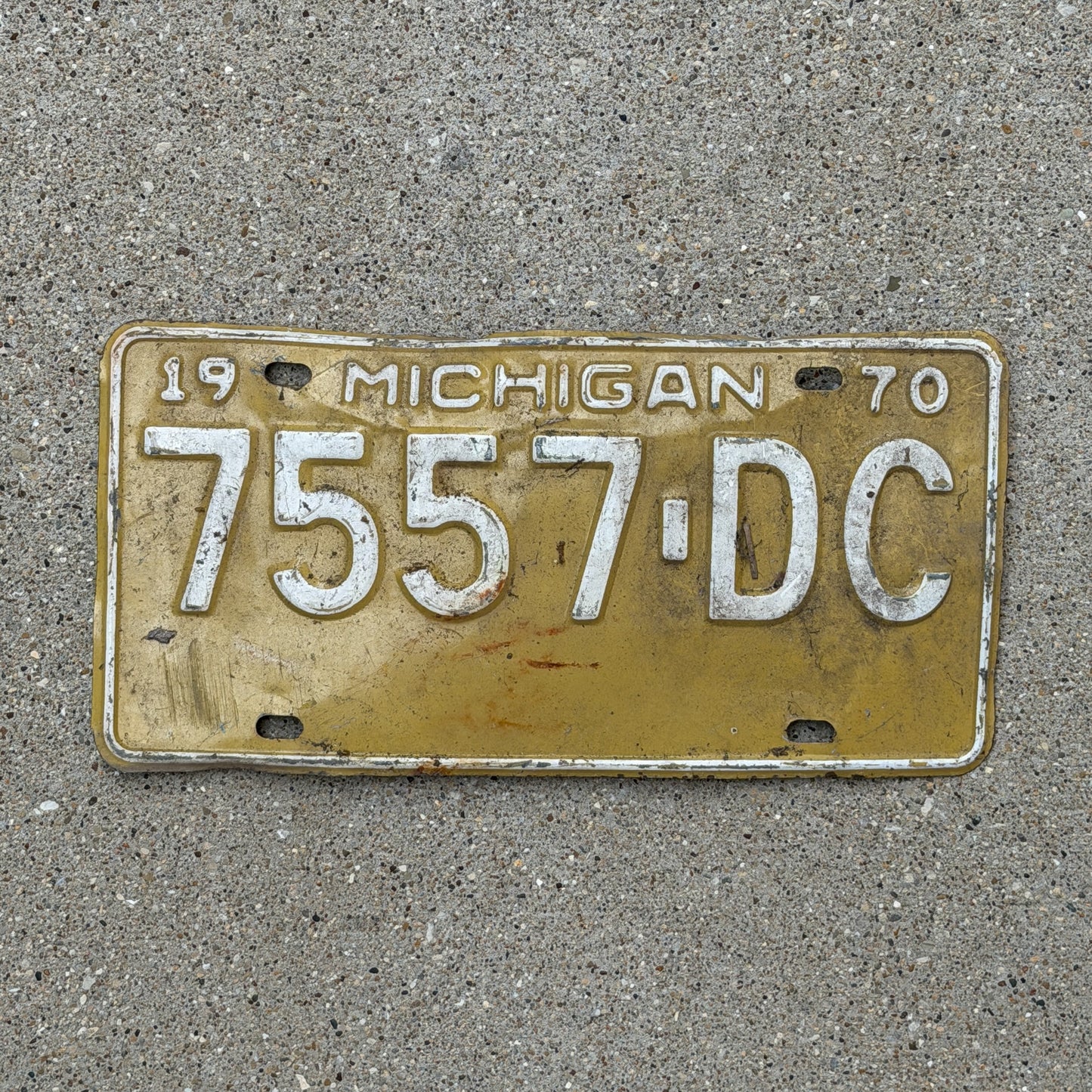 Photo of a 1970 Michigan Commercial License Plate Auto Tag Garage Decor Vintage 7557 DC with original patina