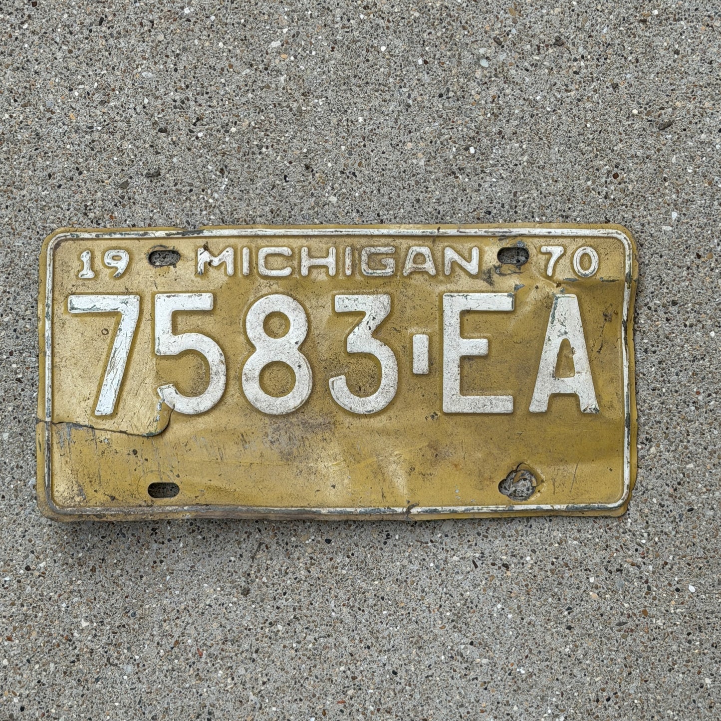 Photo of a 1970 Michigan Commercial License Plate Auto Tag Garage Decor Vintage 7583 EA with original patina