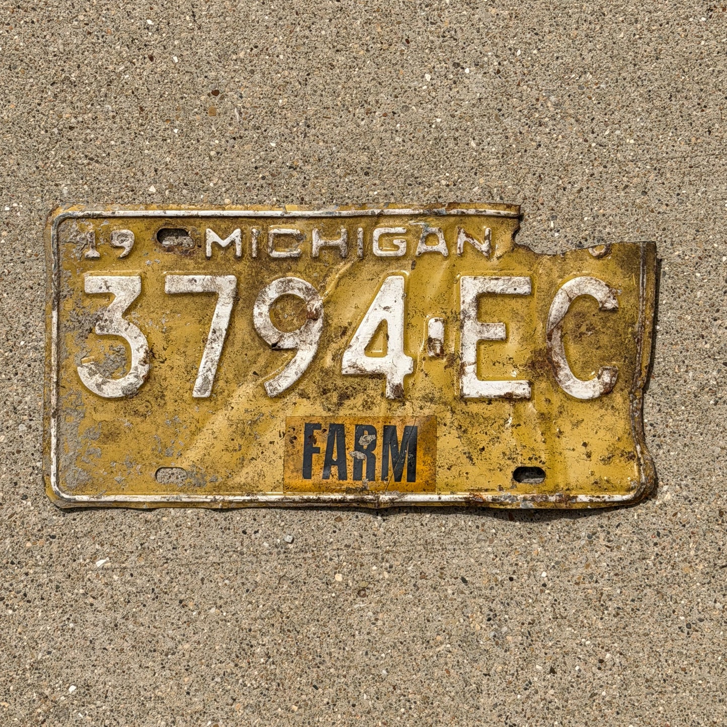 Photo of a 1970 Michigan Farm License Plate Auto Tag Garage Decor Vintage 3794 EC with original patina