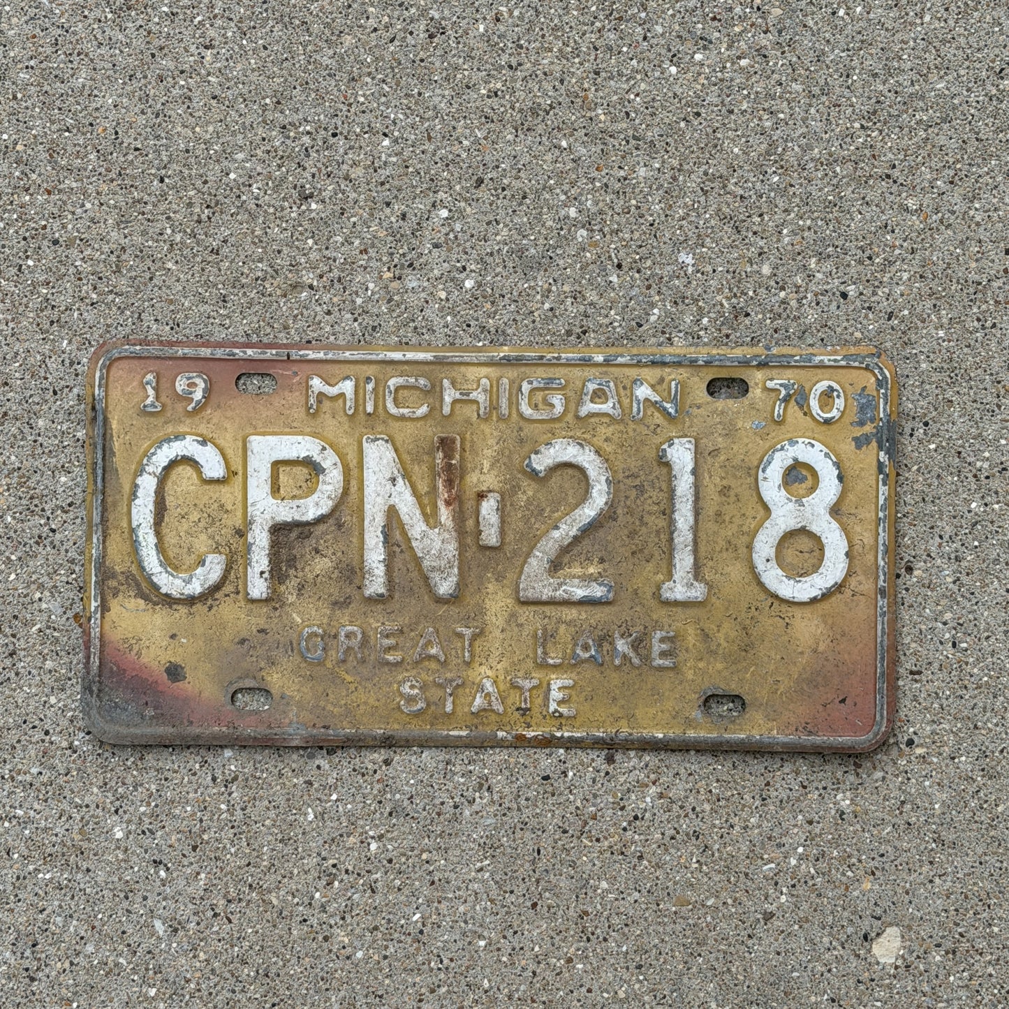 Photo of a 1970 Michigan License Plate Auto Tag 1 Vintage Garage CPN 218 with original patina