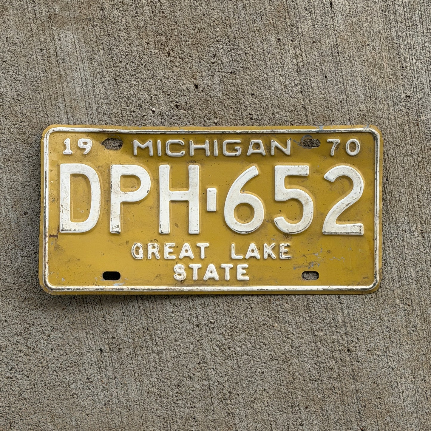 Photo of a 1970 Michigan License Plate Auto Tag 2 Vintage Garage DPH 652 with original patina