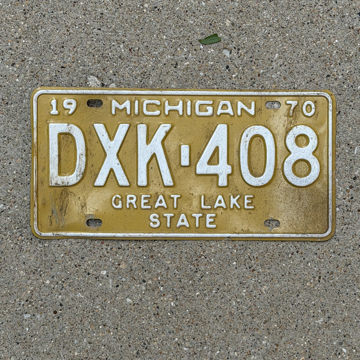 Photo of a 1970 Michigan License Plate Auto Tag Garage Decor Vintage DXK 408 with original patina