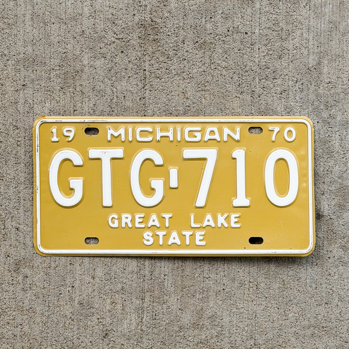 Photo of a 1970 Michigan License Plate Auto Tag Garage Decor Vintage GTG 710 with original patina