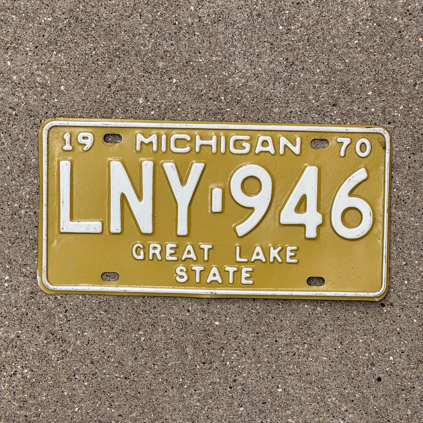 Photo of a 1970 Michigan License Plate Auto Tag Garage Decor Vintage Yellow LNY 946