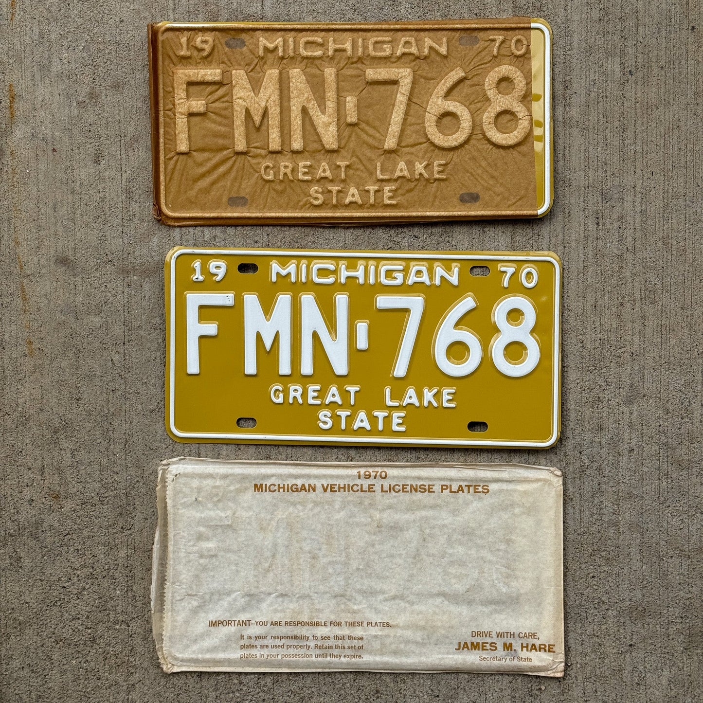 Photo of a 1970 Michigan License Plate Pair Auto Tag Garage Decor Vintage NOS with Original Mailing Envelope FMN 768