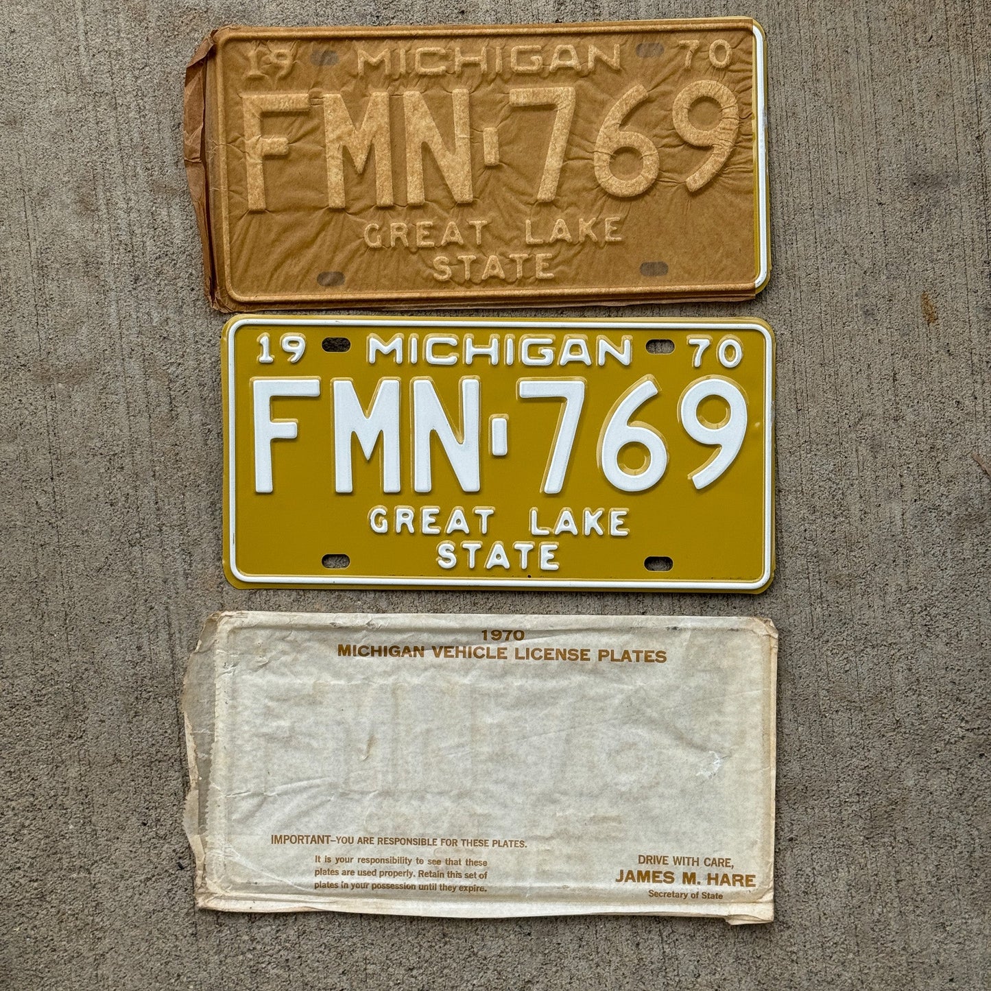 Photo of a 1970 Michigan License Plate Pair Auto Tag Garage Decor Vintage NOS with Original Mailing Envelope FMN 769