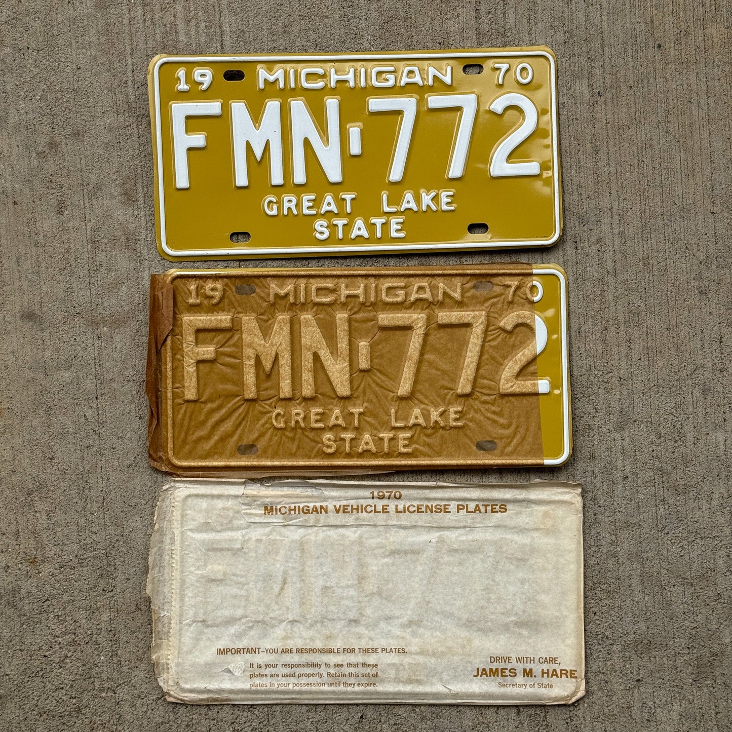 Photo of a 1970 Michigan License Plate Pair Auto Tag Garage Decor Vintage NOS with Original Mailing Envelope FMN 772