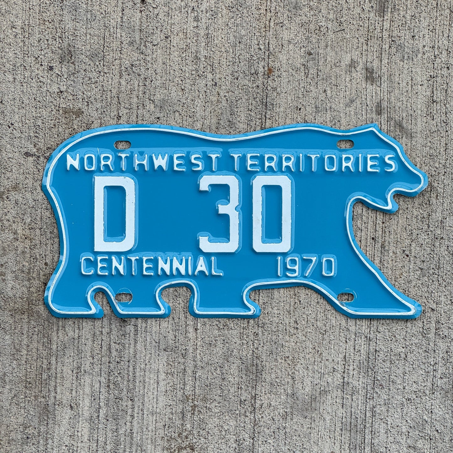 Photo of a 1970 Northwest Territories Dealer License Plate Auto Tag Garage Decor Vintage Polar Bear Centennial Low Number Two Digit D 30 with original patina
