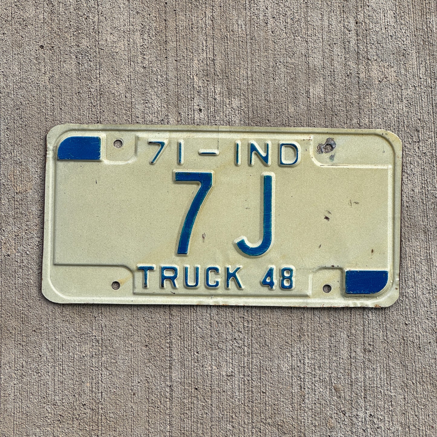 Photo of a 1971 Indiana Truck License Plate Auto Tag Garage Decor Vintage Low Number 7 J with original patina