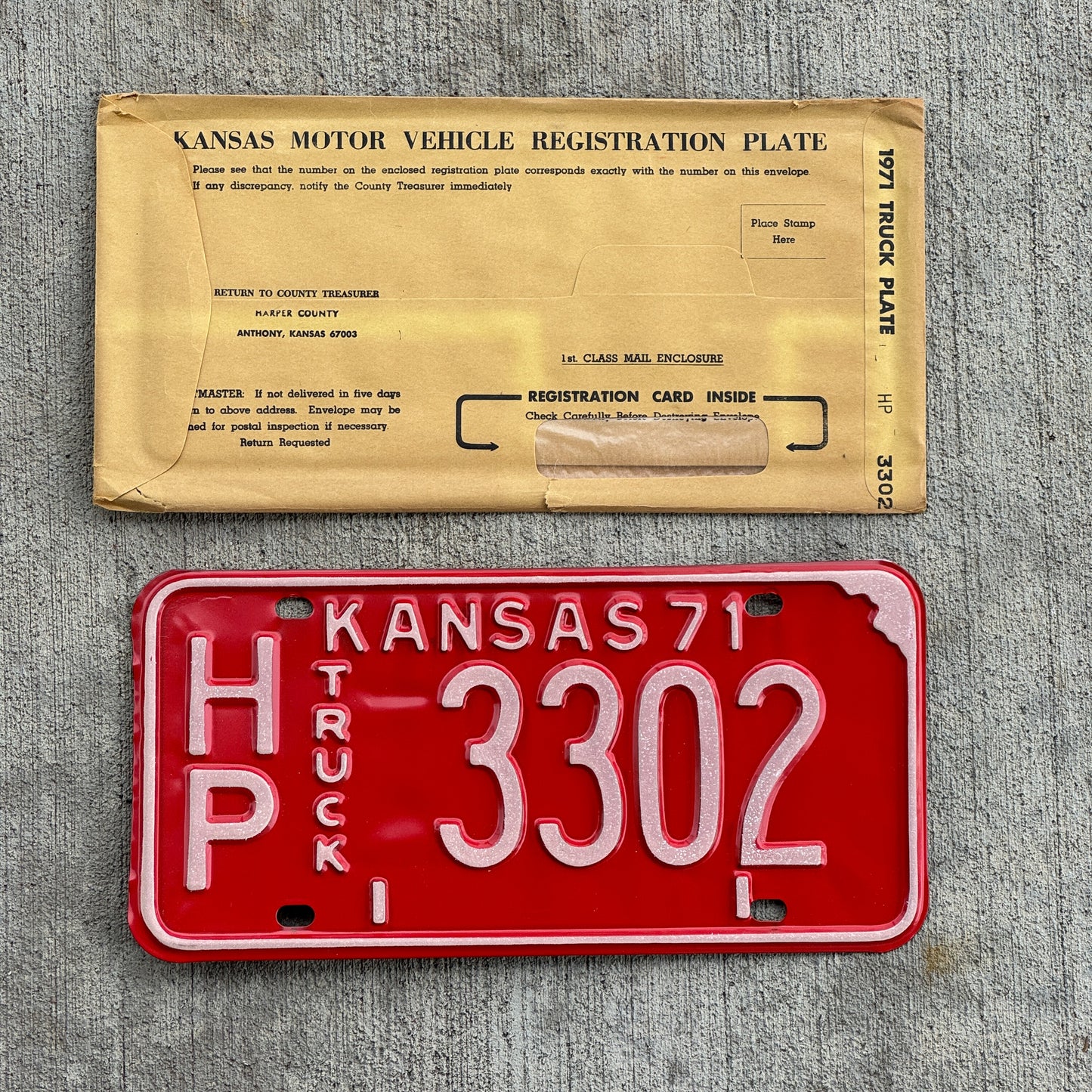 Photo of a 1971 Kansas Truck License Plate Auto Tag Garage Decor Vintage New Old Stock With Envelope HP 3302 with original patina
