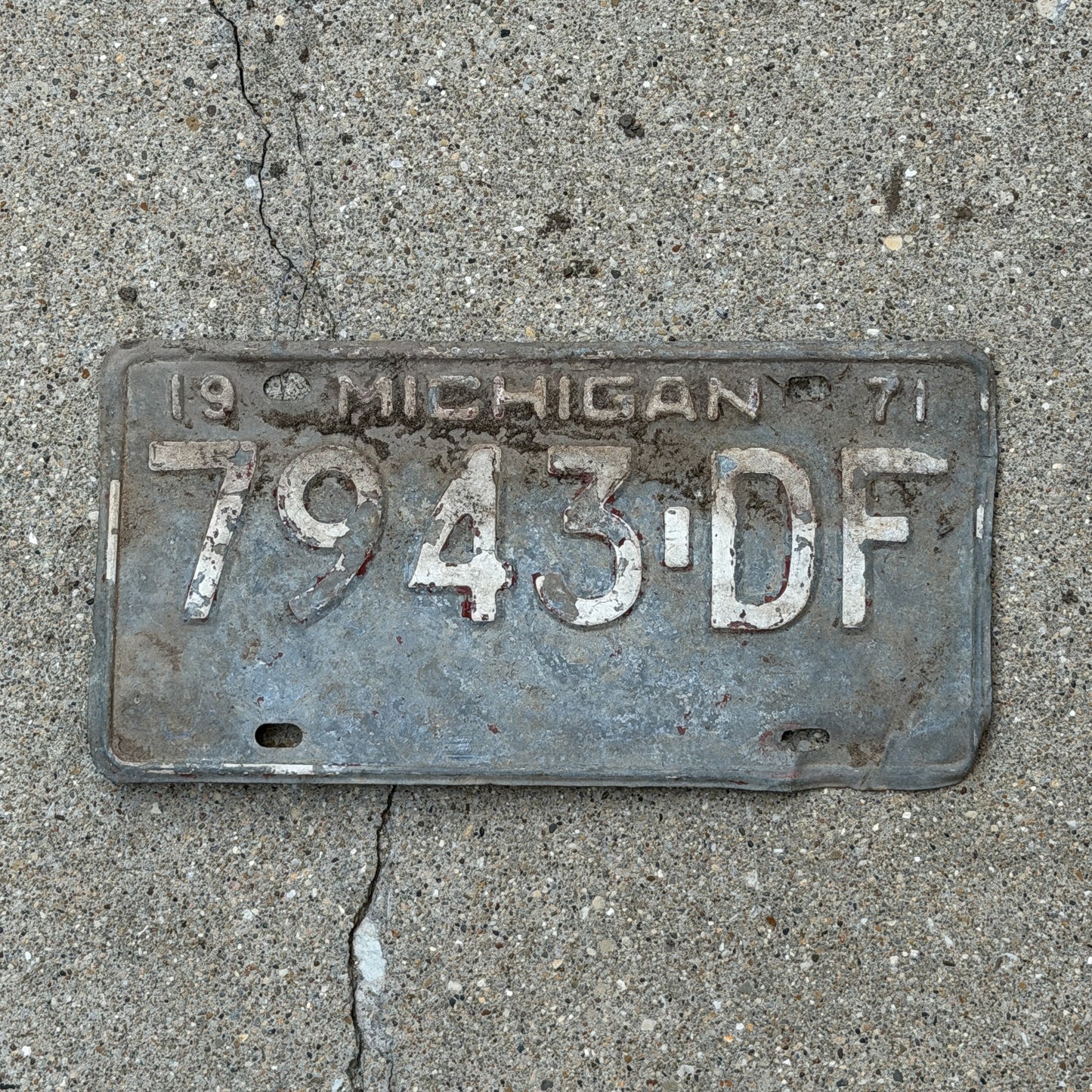 Photo of a 1971 Michigan Commercial License Plate Auto Tag Garage Decor Vintage 7943 DF with original patina