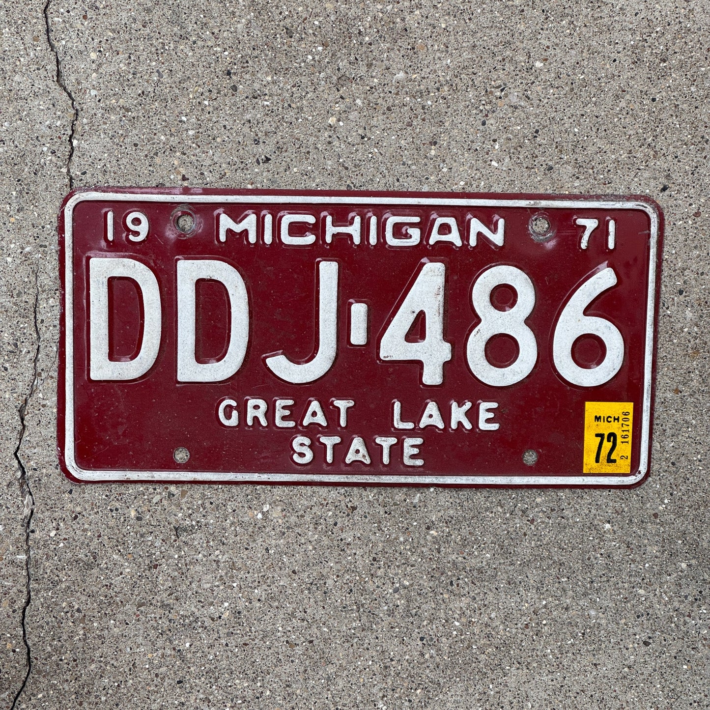 Photo of a 1971 Michigan License Plate Auto Tag Garage Decor Vintage Red White DDJ 486