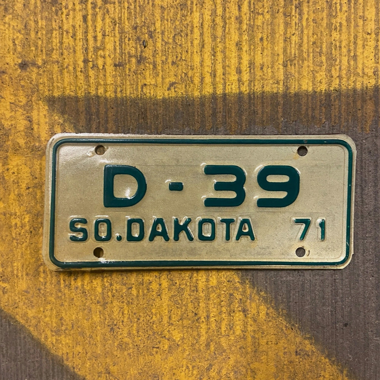 Photo of a 1971 South Dakota Motorcycle Dealer License Plate Auto Tag Garage Decor Vintage Low Number Two Digit D 39 with original patina