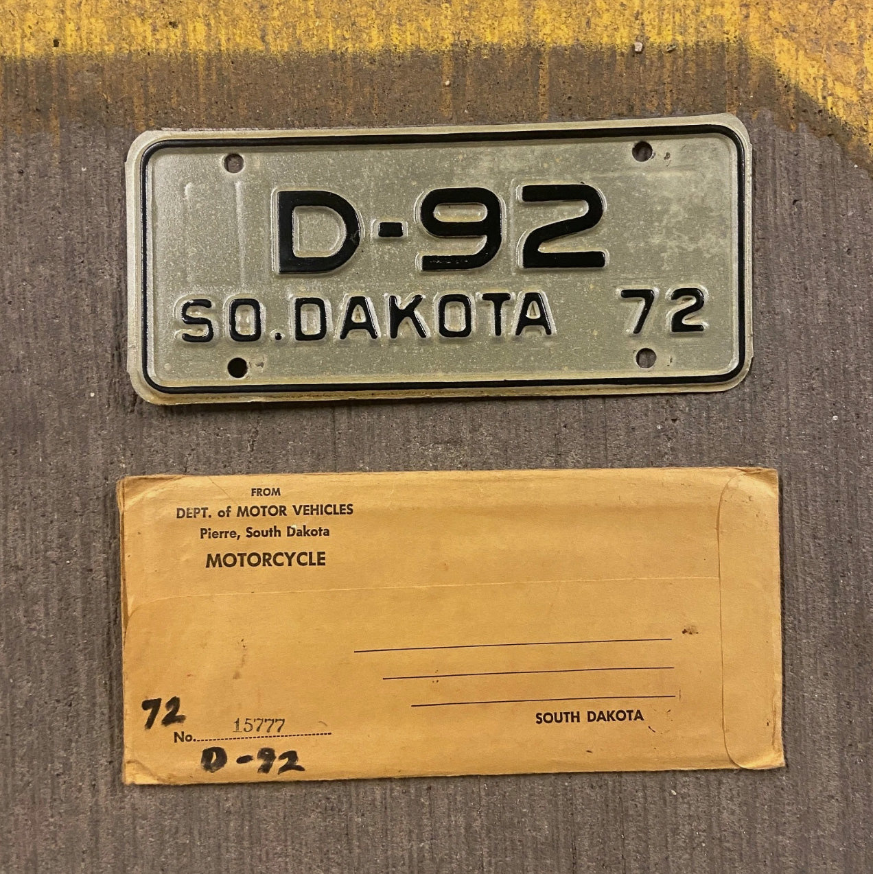Photo of a 1972 South Dakota Motorcycle Dealer License Plate Auto Tag Garage Decor Vintage Low Number Two Digit D 92 with original patina