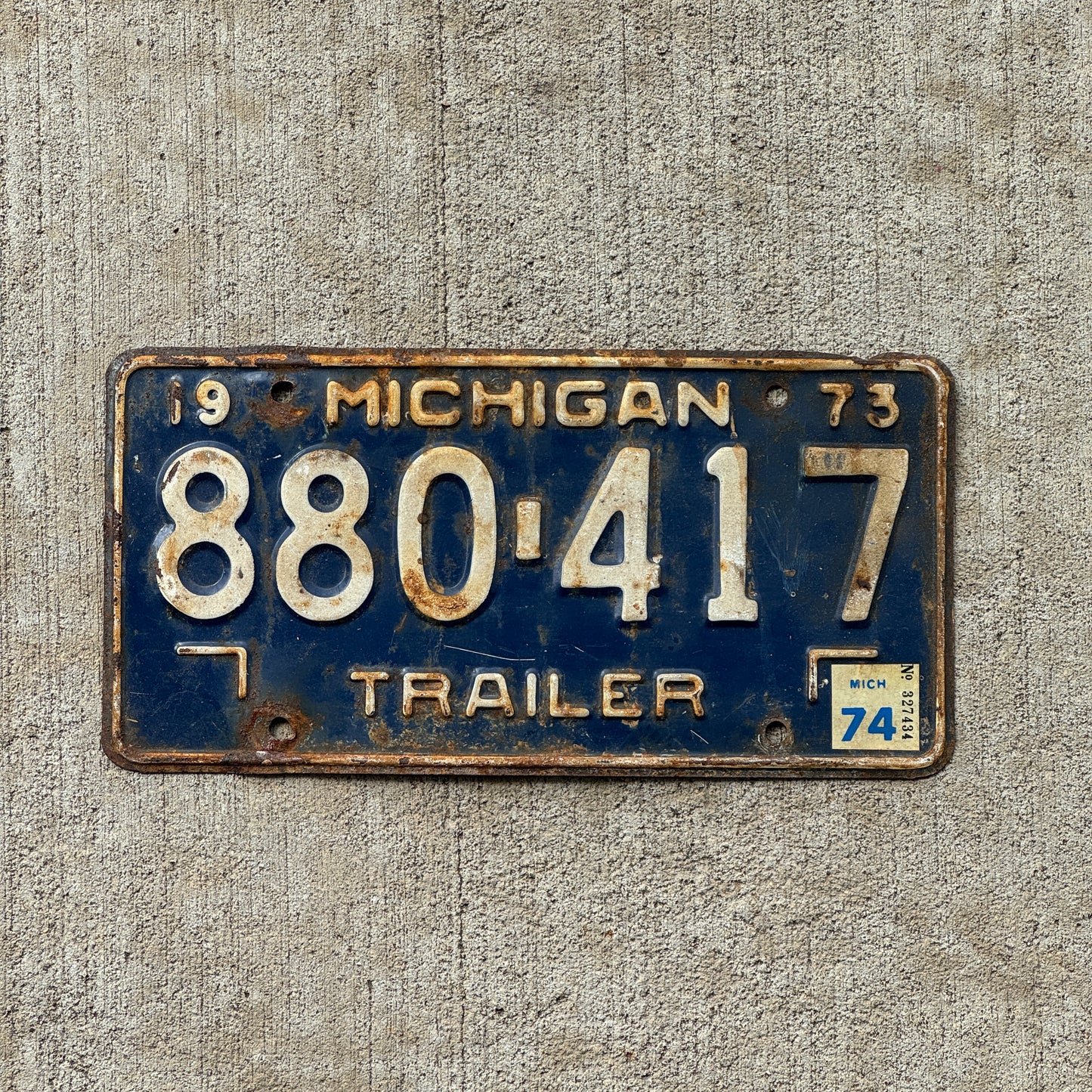 Photo of a 1973 1974 Michigan Trailer License Plate Auto Tag Garage Decor Vintage 880 417 with original patina