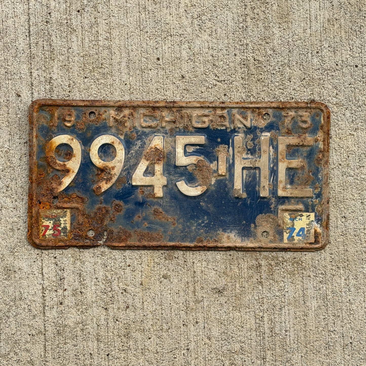 Photo of a 1973 1975 Michigan Commercial License Plate Auto Tag Garage Decor Vintage 9945 HE with original patina