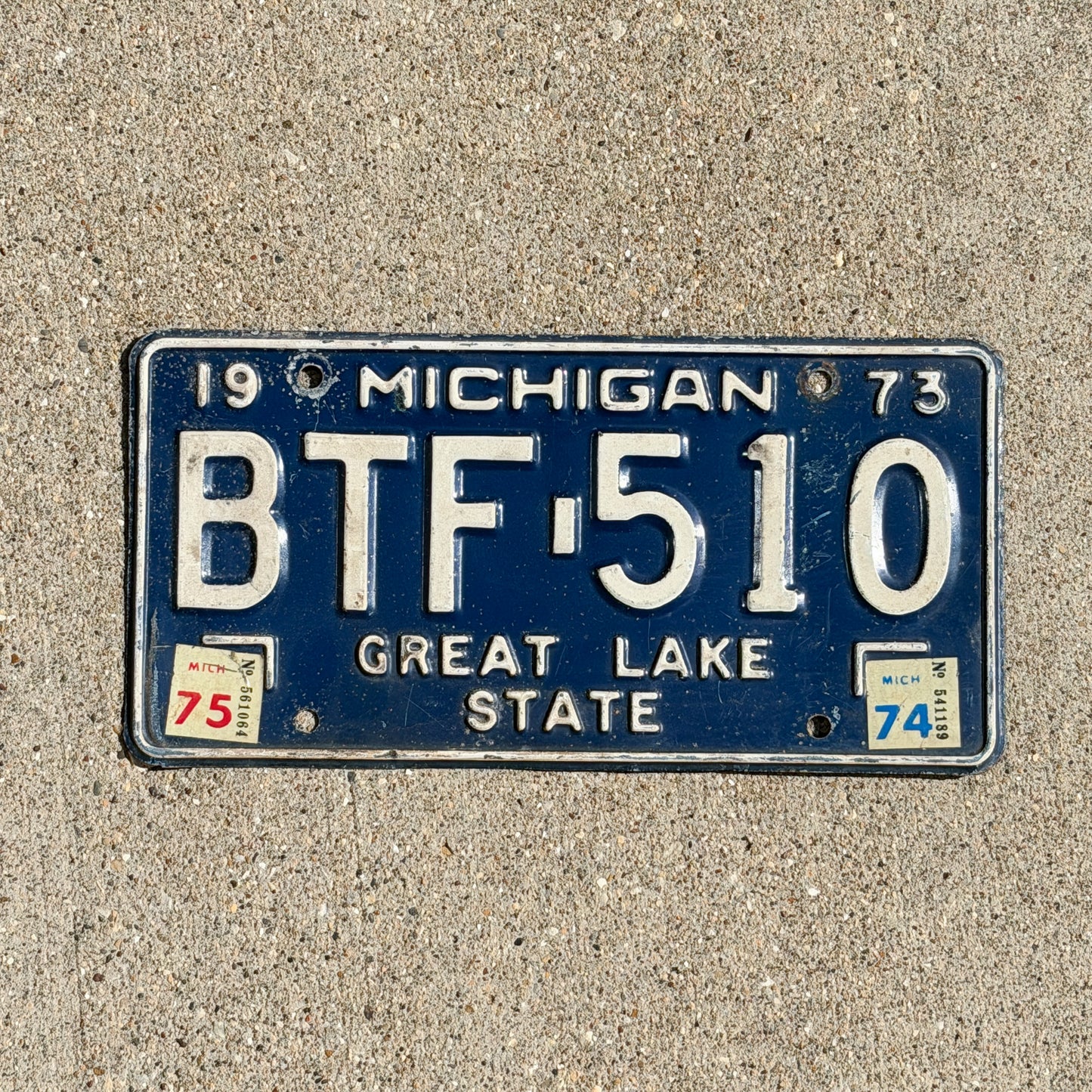 Photo of a 1973 1975 Michigan License Plate Auto Tag Garage Decor Vintage BTF 510 with original patina