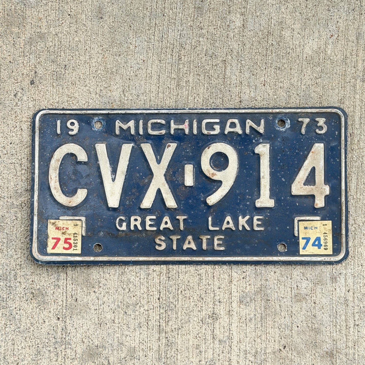 Photo of a 1973 1975 Michigan License Plate Auto Tag Garage Decor Vintage CVX 914 with original patina
