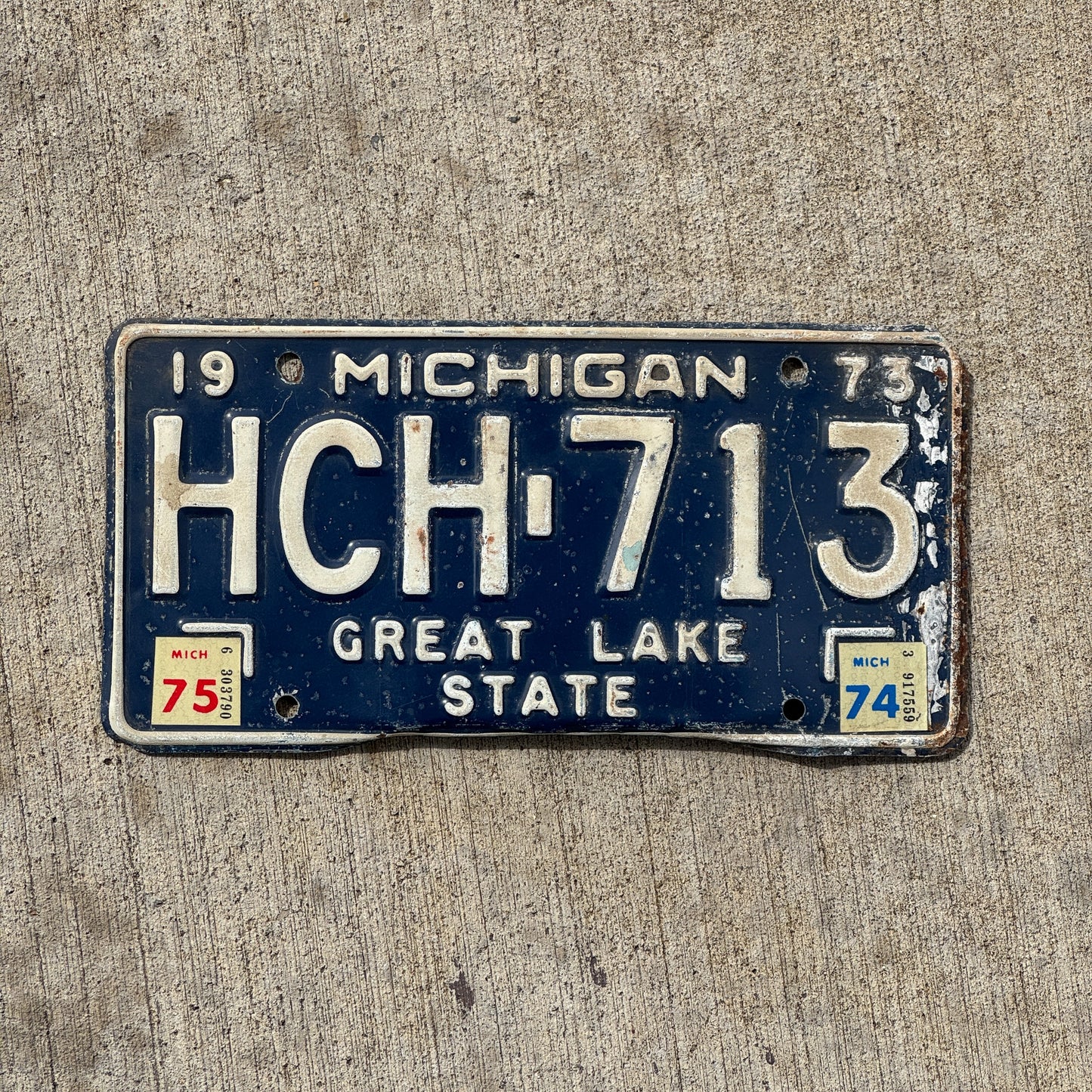 Photo of a 1973 1975 Michigan License Plate Auto Tag Garage Decor Vintage HCH 713 with original patina