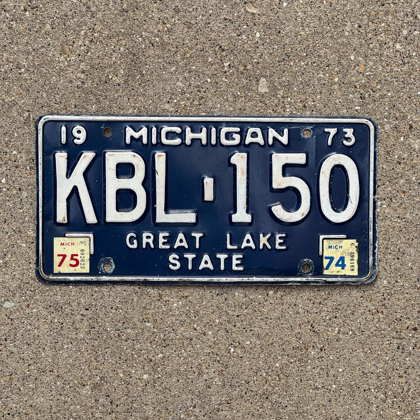 Photo of a 1973 1975 Michigan License Plate Auto Tag Garage Decor Vintage KBL 150 with original patina