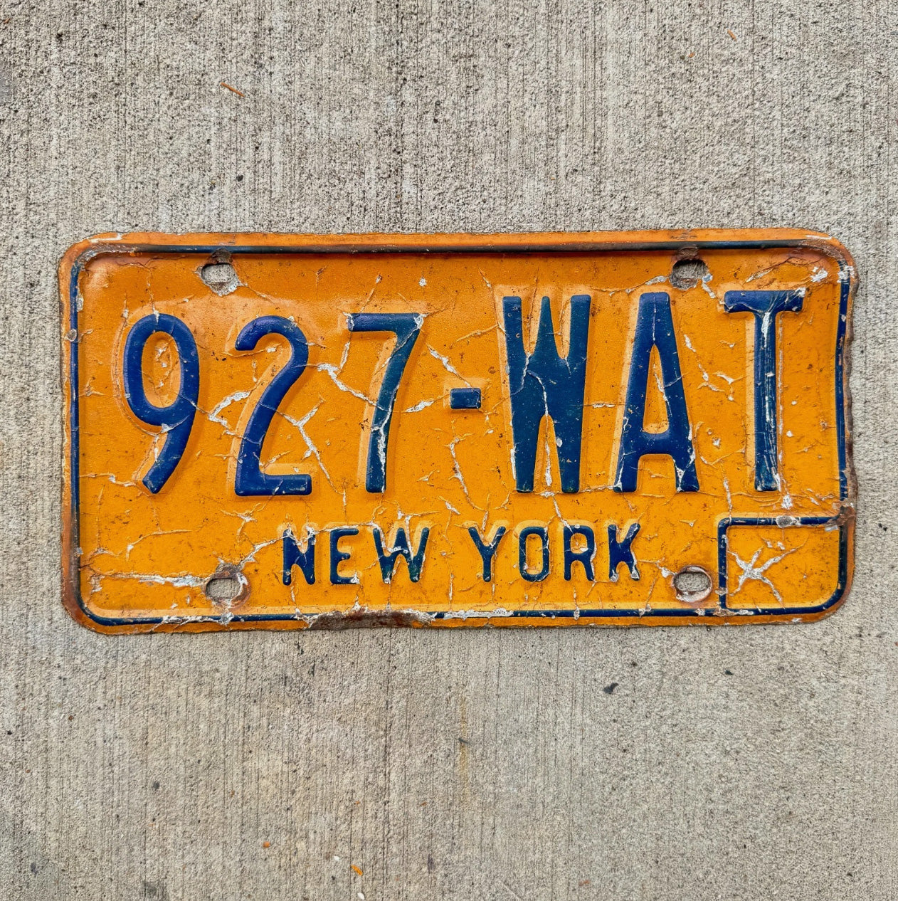 Photo of a 1973 1986 New York License Plate Auto Tag Garage Decor Vintage Orange 927 WAT