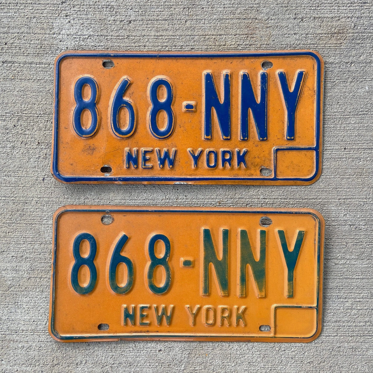 Photo of a 1973 1986 New York License Plate Pair Auto Tag Garage Decor Vintage YOM DMV Clear 868 NNY with original patina