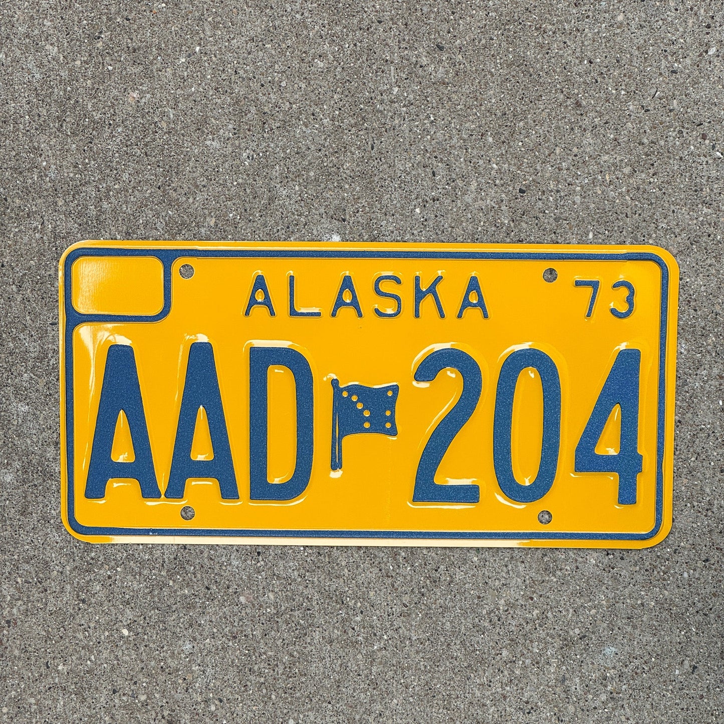 Photo of a 1973 Alaska License Plate Auto Tag Garage Decor Vintage Less than 3600 Made, Hard to Find AAD 204 with original patina
