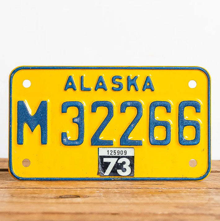 Photo of a 1973 Alaska Motorcycle License Plate Auto Tag Garage Decor Vintage M 32266 with original patina